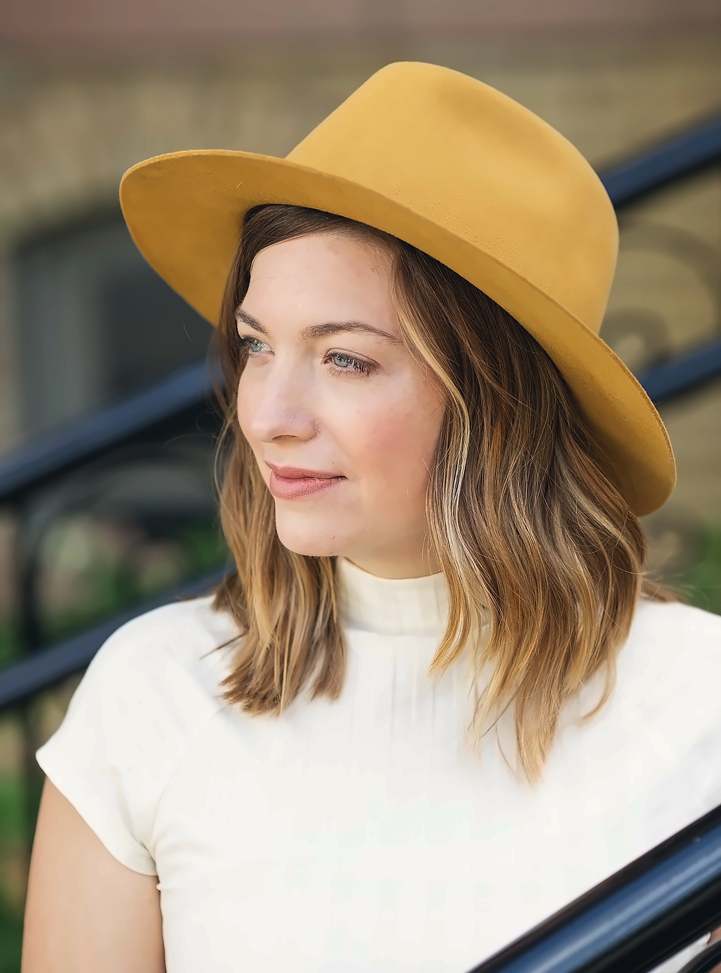 Editorial portrait of a woman in a wide-brimmed hat