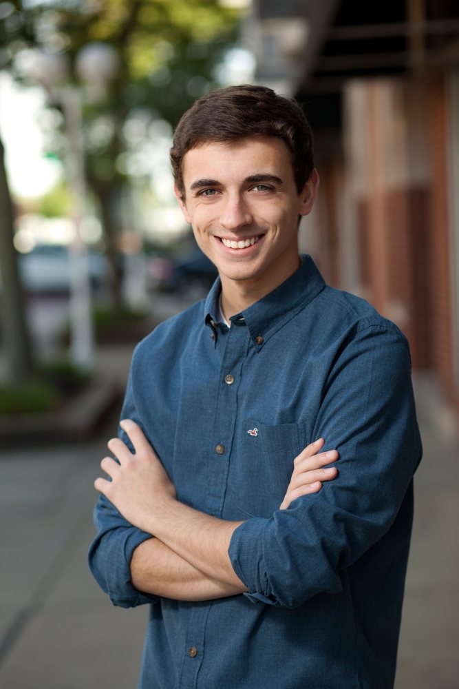 Senior portrait of a young man on a city street