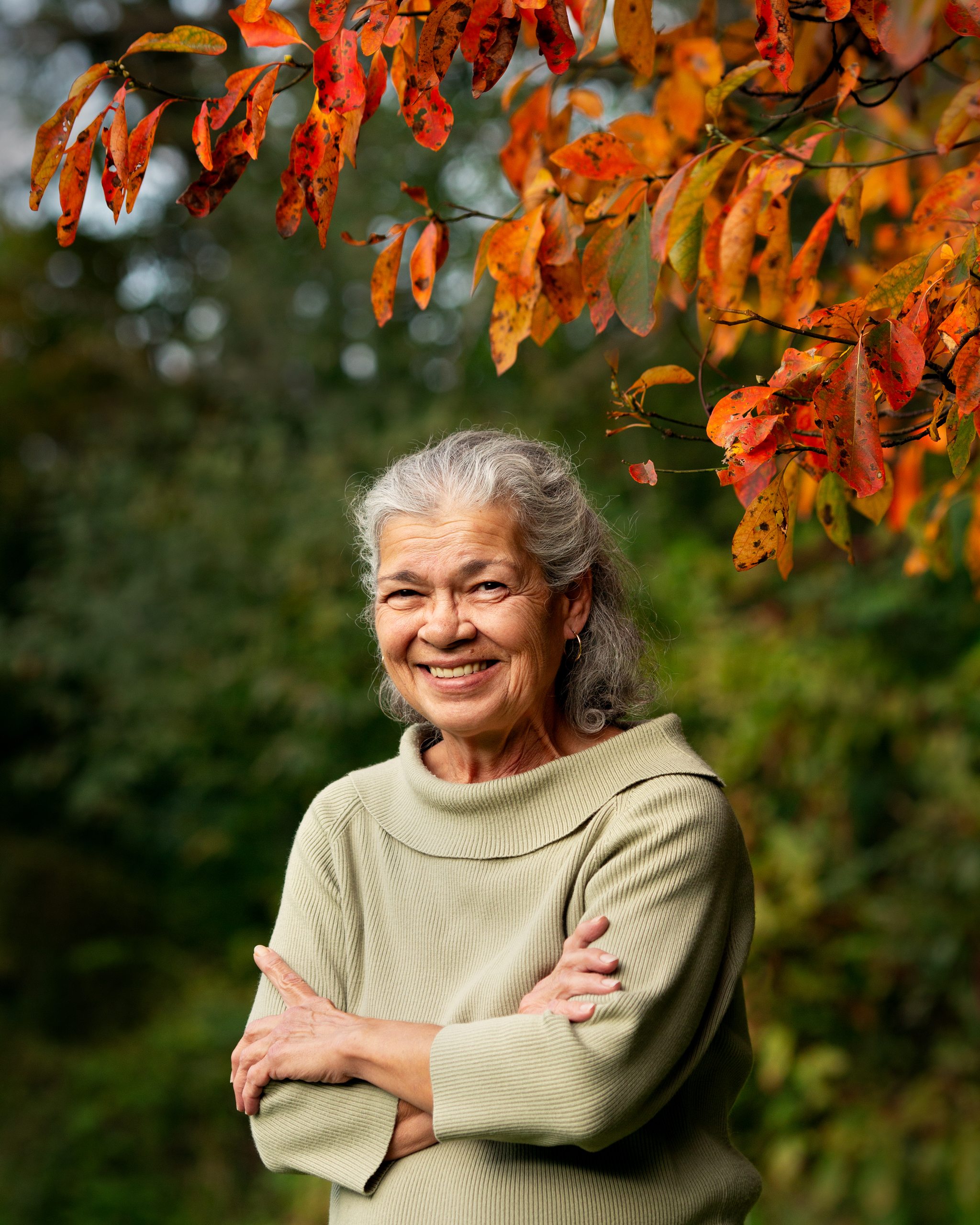 Portrait of a woman smiling among autumn leaves