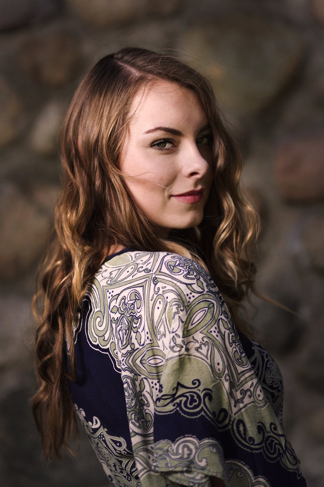Senior portrait of a young woman with long curls