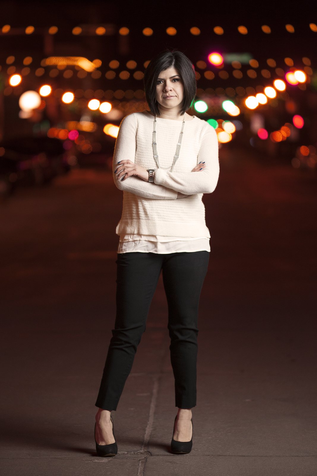 Portrait of a woman on a city street at night