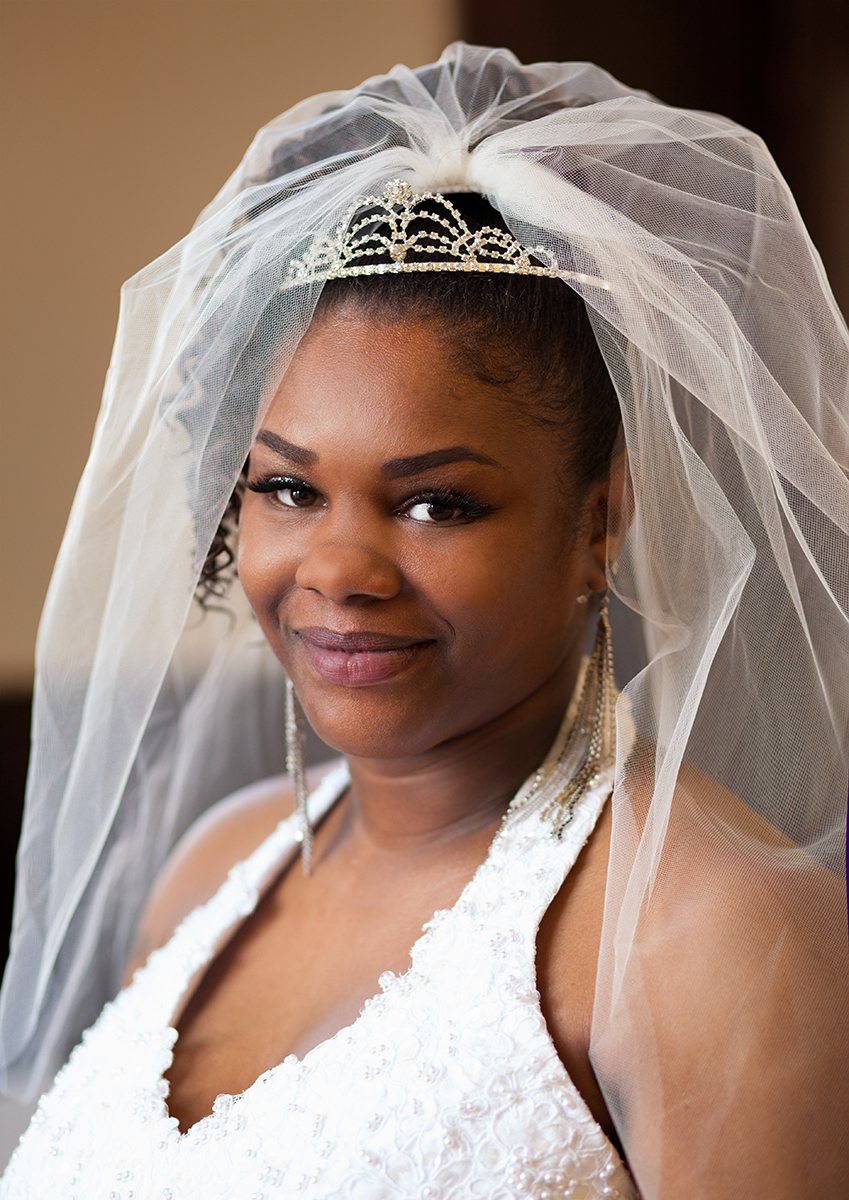 Bride smiling in her veil and tiara on her wedding day